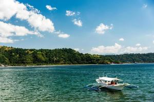 a boat in the middle of a large body of water at Hotel Avenija in Olongapo