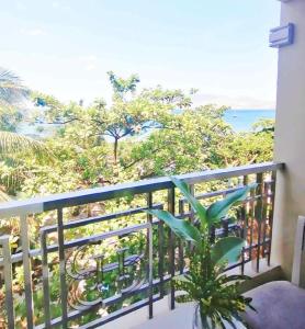 a balcony with a view of the ocean at Subic Grand Harbour Hotel Subic Bay in Olongapo