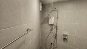 a bathroom with a shower with a shower head at Neighbor Hostel in Haad Rin