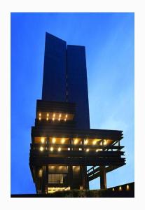 a building with lights in front of a tall building at The Bono Hotel Pekanbaru in Pekanbaru