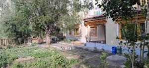a house with a garden in front of it at KARMA Homestay Sumur Nubra in Nubra