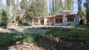 a house in the middle of a garden at KARMA Homestay Sumur Nubra in Nubra