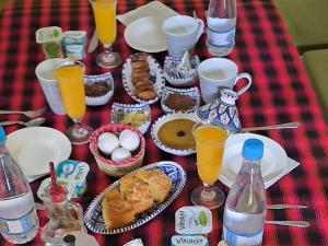 a table with breakfast foods and drinks on it at Dar fatma medenine in Medenine