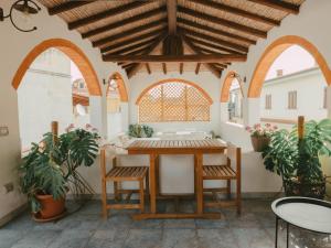 a patio with a table and chairs in a building at Domu Elvira in Muravera