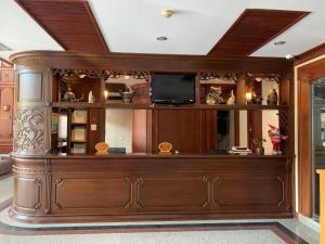 a large wooden entertainment center with a television on top at Leuxay Hotel in Ban Houadông