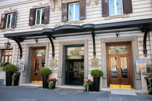a facade of a building with doors and windows at Hotel Mecenate Palace in Rome