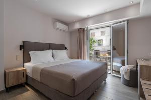 Postel nebo postele na pokoji v ubytování Piraeus City Hotel