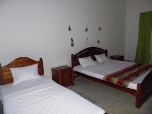 two beds in a room with at Lagoon Beach Resort in Tangalle