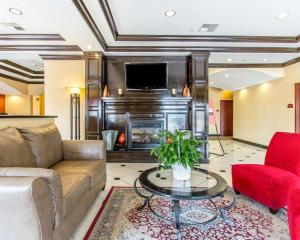 a living room with a couch and a fireplace at Comfort Inn & Suites Atoka in Atoka