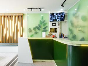 a lobby with a counter with a tv on the wall at Mi Linh Hotel in Ho Chi Minh City