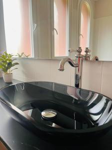 a black sink with a faucet in a bathroom at Apartamento del Conde in Jaca +19 photos