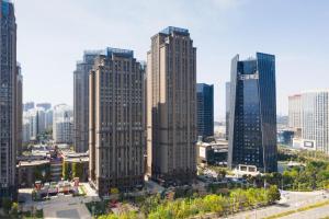 a group of tall buildings in a city at Vienna Hotel Yunnan Chunrong Street Qicai Yunan in Kunming