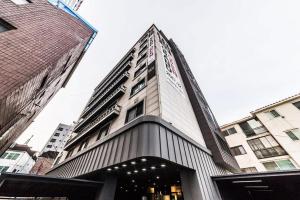 a building with a clock on the side of it at Uijeongbu Hotel Bene in Ŭijŏngbu-yŏk