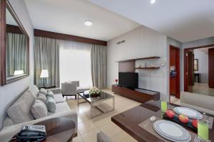 a living room with a couch and a table at SUHA JBR Hotel Apartments in Dubai