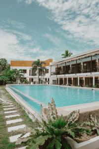 a large swimming pool in front of a building at Keep Diving Resort Bohol in Panglao