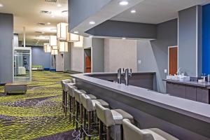 a bar with a row of chairs in a waiting room at Fairfield Inn & Suites by Marriott Liberal in Liberal +21 photos