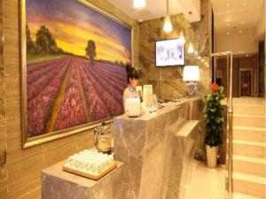 a restaurant with a flower painting on the wall at Lavande Hotel Shanghai Railway Station Branch in Shanghai