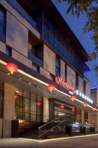 a building with a sign on the side of it at Hampton by Hilton Xi'an Dayan Pagoda in Xi'an