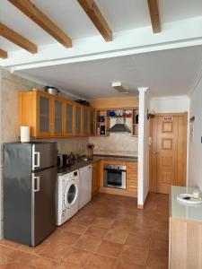 a kitchen with a refrigerator and a dishwasher at Porto Covo / Costa Alentejana in Porto Covo +27 photos