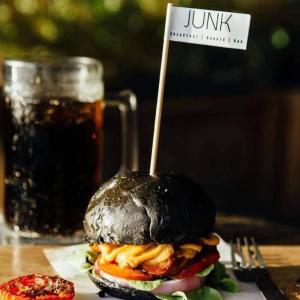 a hamburger with a sign on it with a drink at Betta Hostel in Ban Thai Don (1)