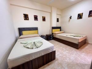 two beds in a room with two beds at Reef House in Marsa Alam City +261 photos