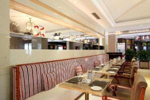 a restaurant with tables and chairs and a bar at Great International Hotel in Heyuan