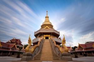 a building with stairs leading up to a tower at Poompimaan House in Udon Thani