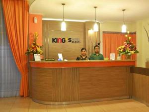 two people sitting at a reception counter in a hospital at Hotel Kings Kudus in Kudus +89 photos