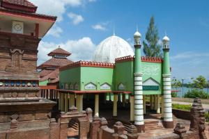 a building with a mosque in the background at Hotel Kings Kudus in Kudus