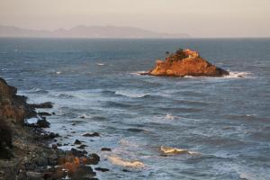 a house on a small island in the ocean at Nam Phuong Hostel 2 in Vung Tau