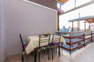 a dining room with a table and chairs and a kitchen at Apartments Draga in Sukošan +46 photos