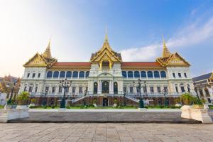 a large building with gold spires on top of it at Thamrongin Hotel in Bangkok