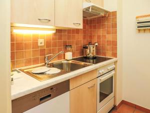 a small kitchen with a sink and a stove at Apartment Rosablanche A24 by Interhome in Siviez