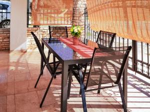 a black table and chairs on a balcony at Apartment Danica-1 by Interhome in Peroj