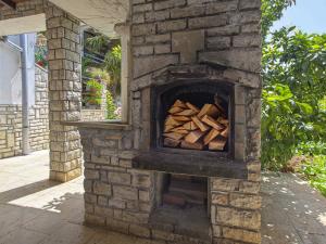 a brick oven with a pile of wood in it at Apartment Danica-1 by Interhome in Peroj +11 photos