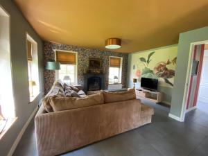 ein Wohnzimmer mit Couch und Kamin in der Unterkunft Holiday Home Wiringherlant-10 by Interhome in Noordstroe + 18 Fotos