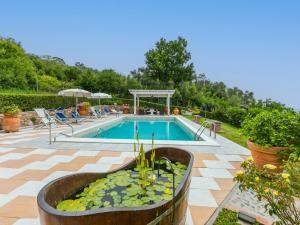 a swimming pool with a water feature in a yard at Holiday Home Al Melo by Interhome in San Gennaro
