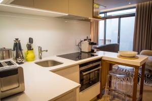 a kitchen with a sink and a counter top at Nicara to Akker Collective in Stellenbosch +20 photos