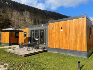 a modern house with a table and an umbrella at Holiday Home Tiny Haus Sonnenplatz by Interhome in Riedenburg