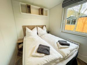 a bedroom with two beds with towels on them at Holiday Home Tiny Haus Christas Angler-Oase by Interhome in Riedenburg +38 photos