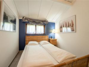 two beds in a small room with blue walls at Holiday Home Noordzeepark Zeewind 2-12 by Interhome in Bredene
