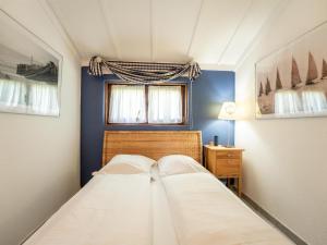 a small bedroom with two beds and a window at Holiday Home Noordzeepark Zeewind 2-12 by Interhome in Bredene