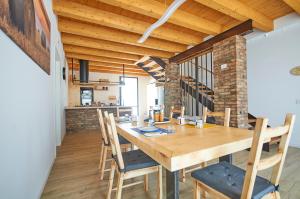 a dining room with a wooden table and chairs at Ca' Brazzo Bed Relais in Pontecasale