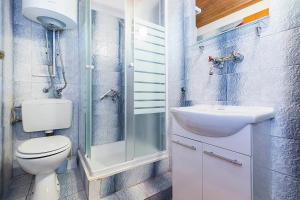 a bathroom with a toilet and a sink and a shower at Apartments Draga in Sukošan