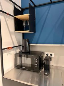 a microwave sitting on top of a counter at Chez Gianni & Stéphanie - A cozy and elegant Studio in Brussels in Brussels