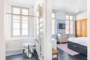 a bedroom with a bed and a bathroom with a tub at Townhouse room heerenhuys in Eeklo