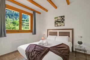 a bedroom with a bed with towels on it at El Tarter Spacious Ski Apartment - Happy Rentals in El Tarter