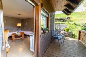 a porch of a house with a table and chairs at Haus Winterberg in Schonach