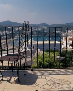 a chair on a balcony with a view of the ocean at Villa Laetitia in Ponza