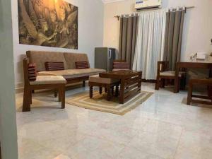 a living room with a couch and a table and chairs at Pleasant 2bhk Holiday Home at Calangute in Calangute